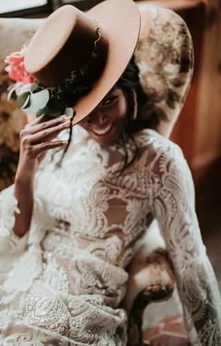 lady wearing a tailored dress and brown hat